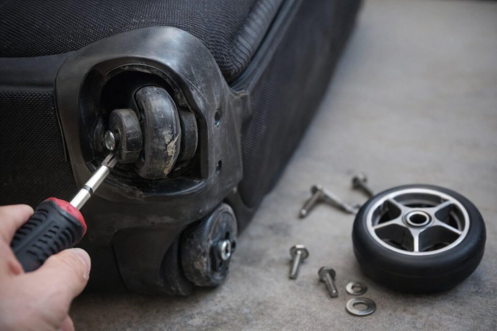 samsonite luggage wheel replacement step by step with screwdriver fixing broken suitcase wheel